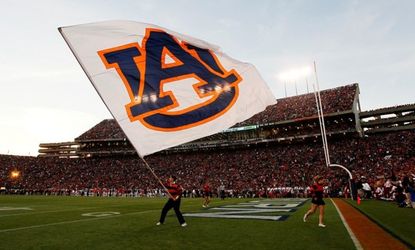 A member of Auburn Tigers cheer team waves a flag during their game against the Alabama Crimson Tide at Jordan-Hare Stadium on November 30.