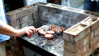 Close up of food being cooked on a brick barbeque