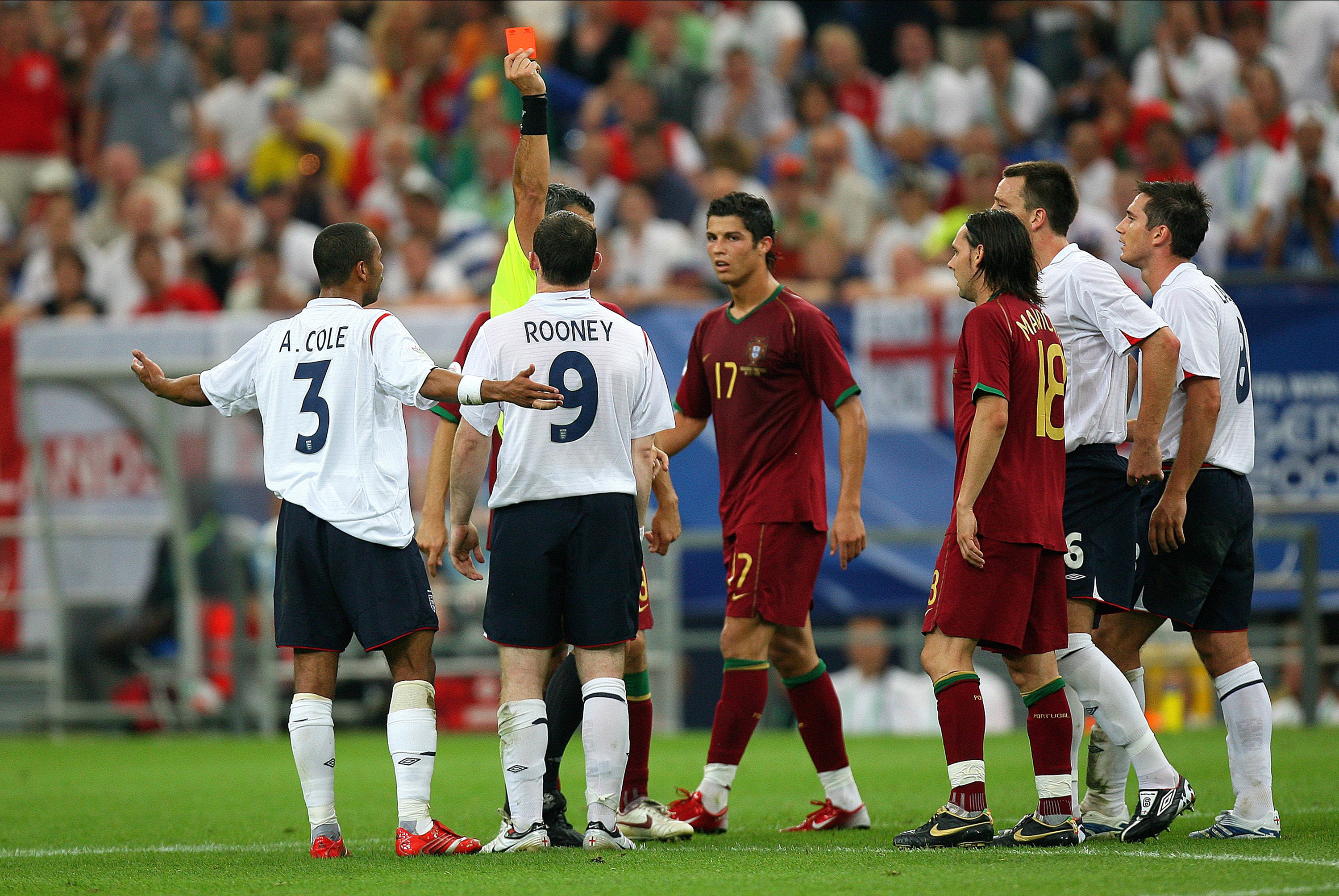 GELSENKIRCHEN, GERMANY - July 1: Wayne Rooney of England is shown Red card and sent off by Referee Horacio Elizondo as Cristiano Ronaldo looks on during the FIFA World Cup Finals 2006 Quarter Final match between England and Portugal at Arena Aufschalke on July 1, 2006 in Gelsenkirchen, Germany. (Photo by Richard Sellers/Sportsphoto/Allstar via Getty Images) *** Local Caption ***Wayne Rooney; Horacio Elizondo; Cristiano Ronaldo