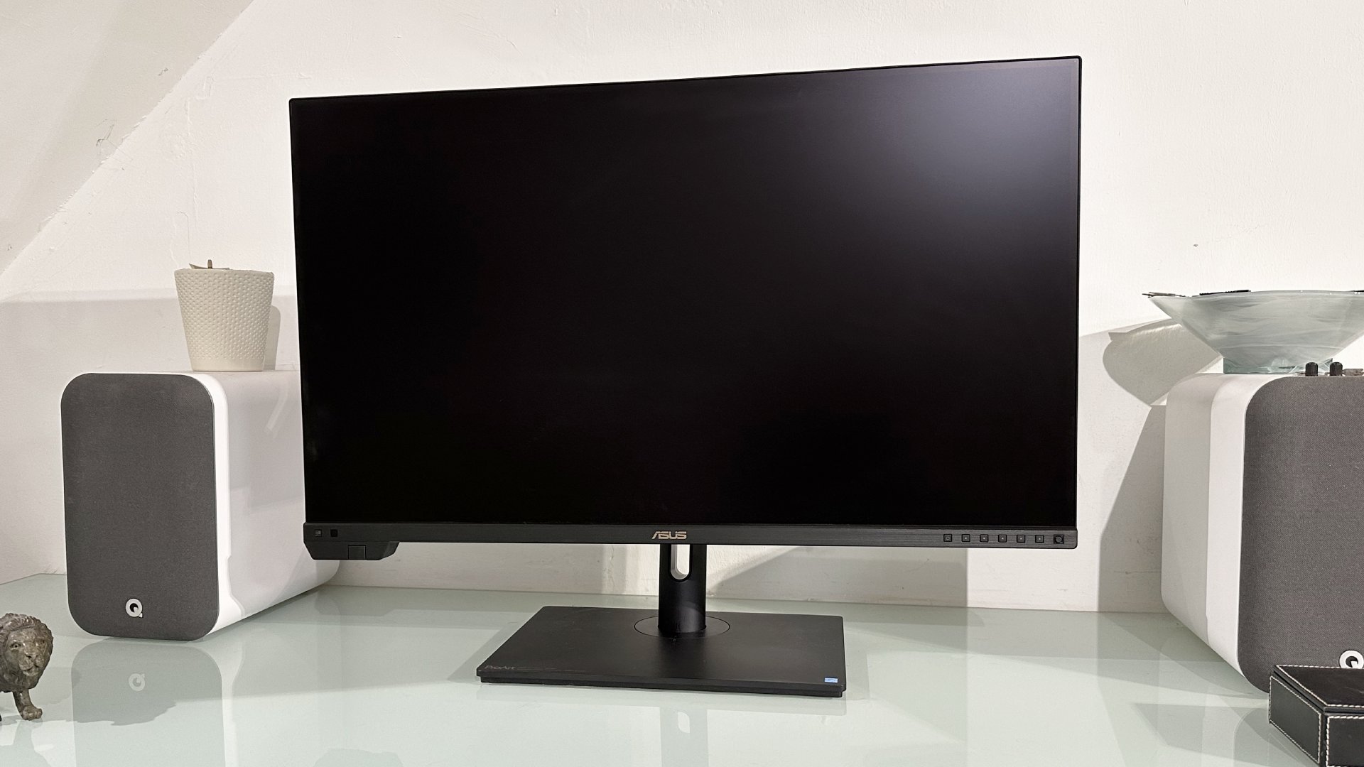 The Asus ProArt PA32KCX 8K monitor on a white desk in a home office during our review process