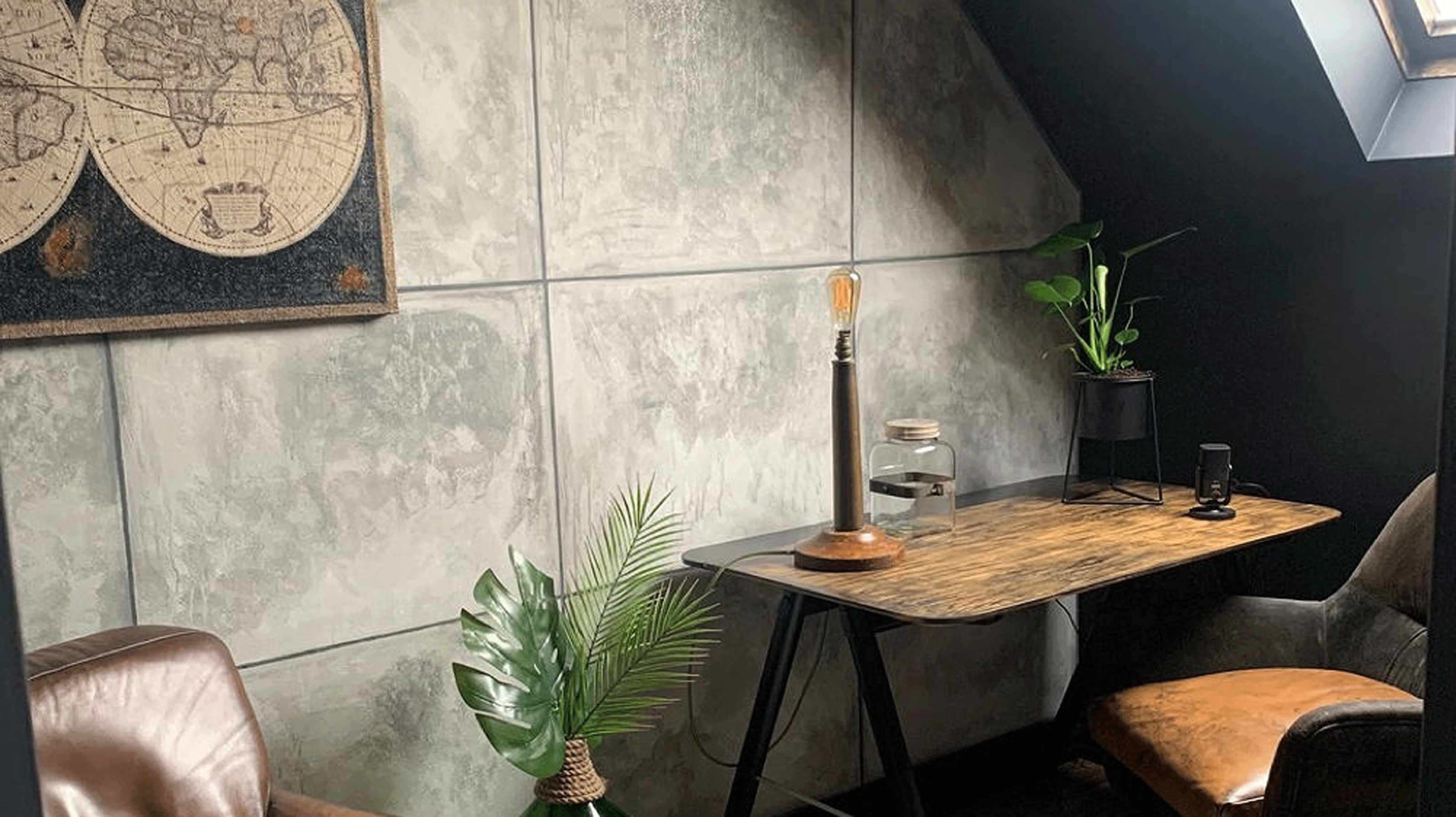 Grey home office with wooden desk and leather chair