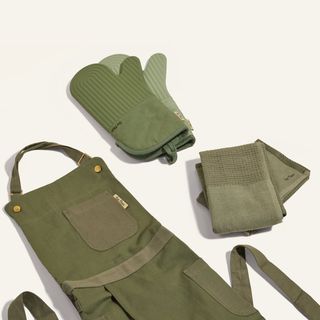 Sage green apron, oven gloves, and tea towel