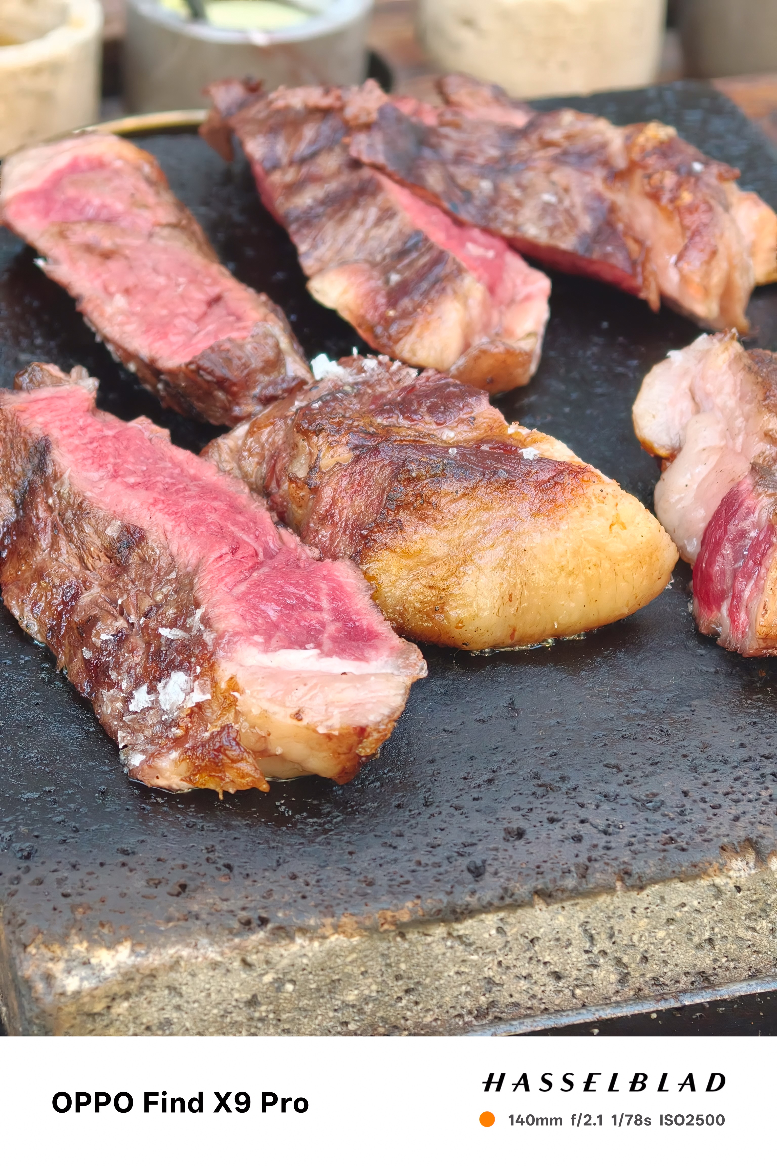 Close-up of meat cooking on a flat slate