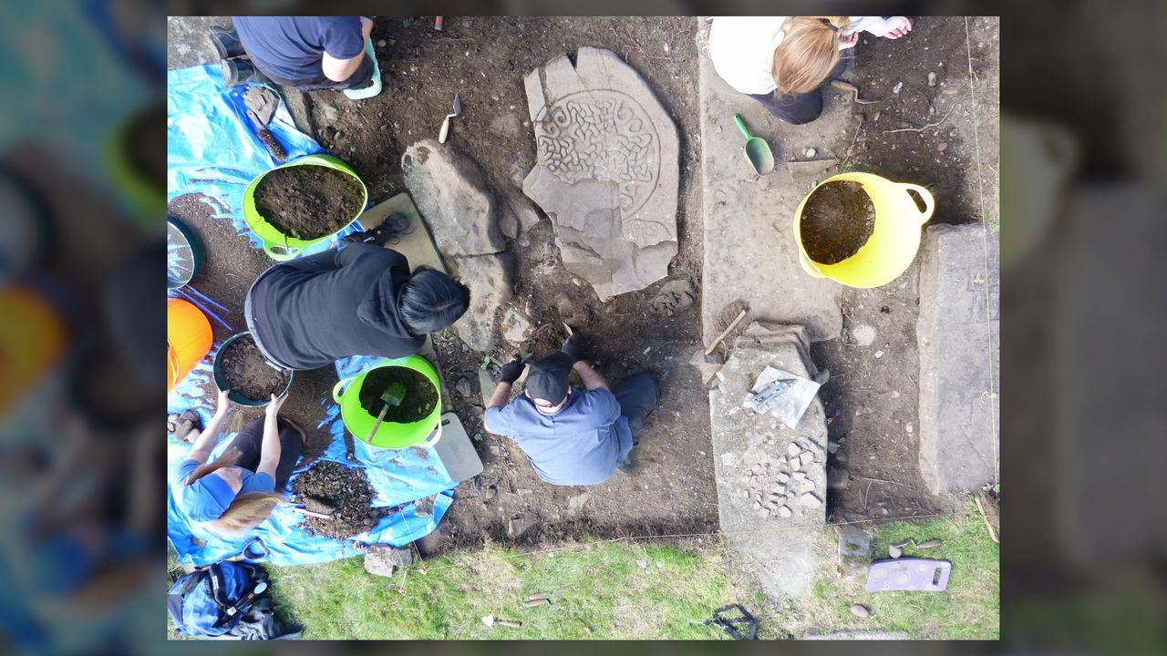 Archaeologist Murray Cook (bottom center) excavates fragments of a Pictish cross slab.