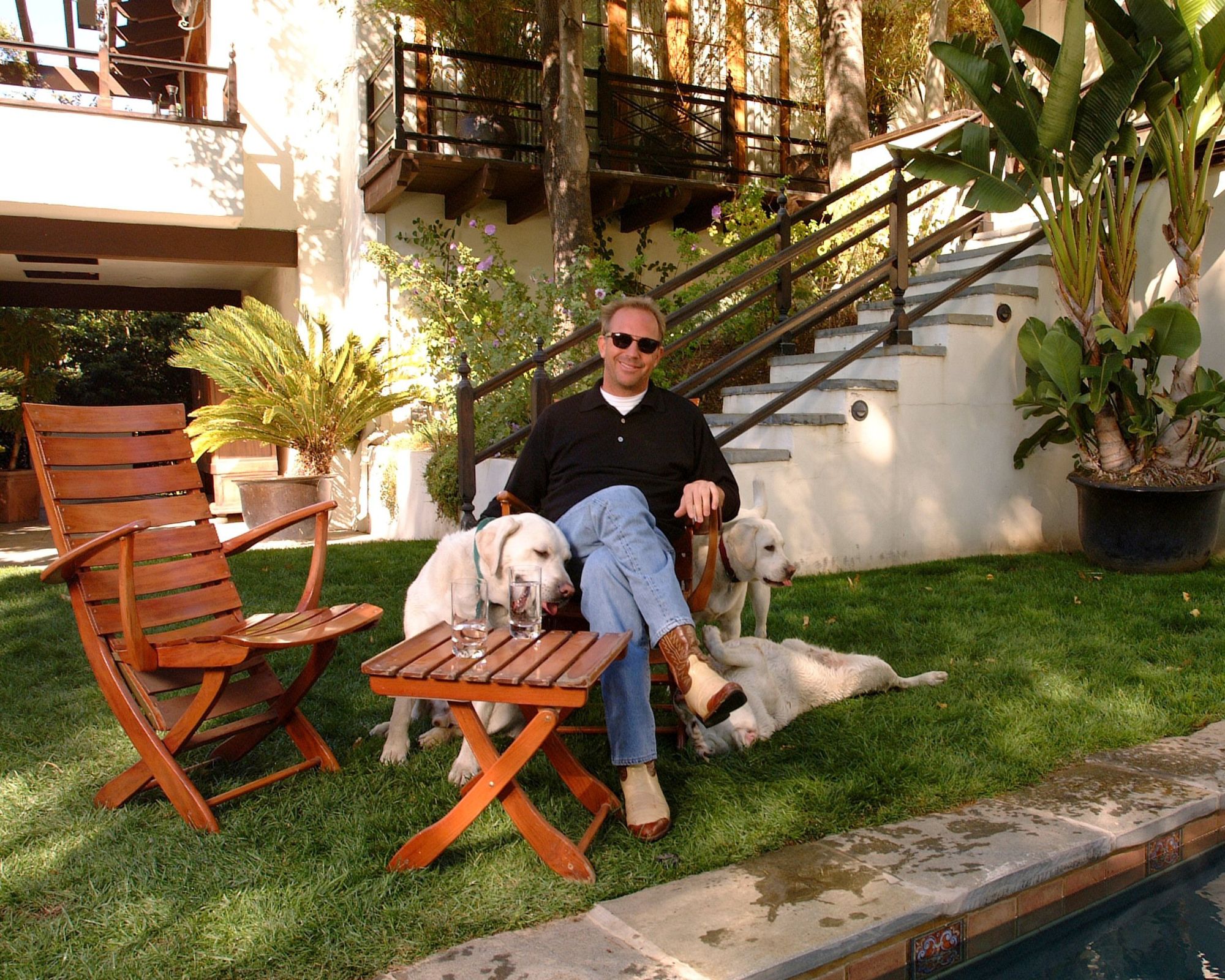 kevin costner in his wooden pool furntiure