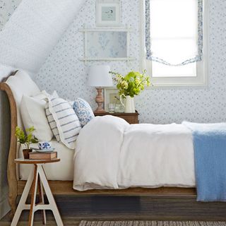 attic bedroom with bed and wallpaper