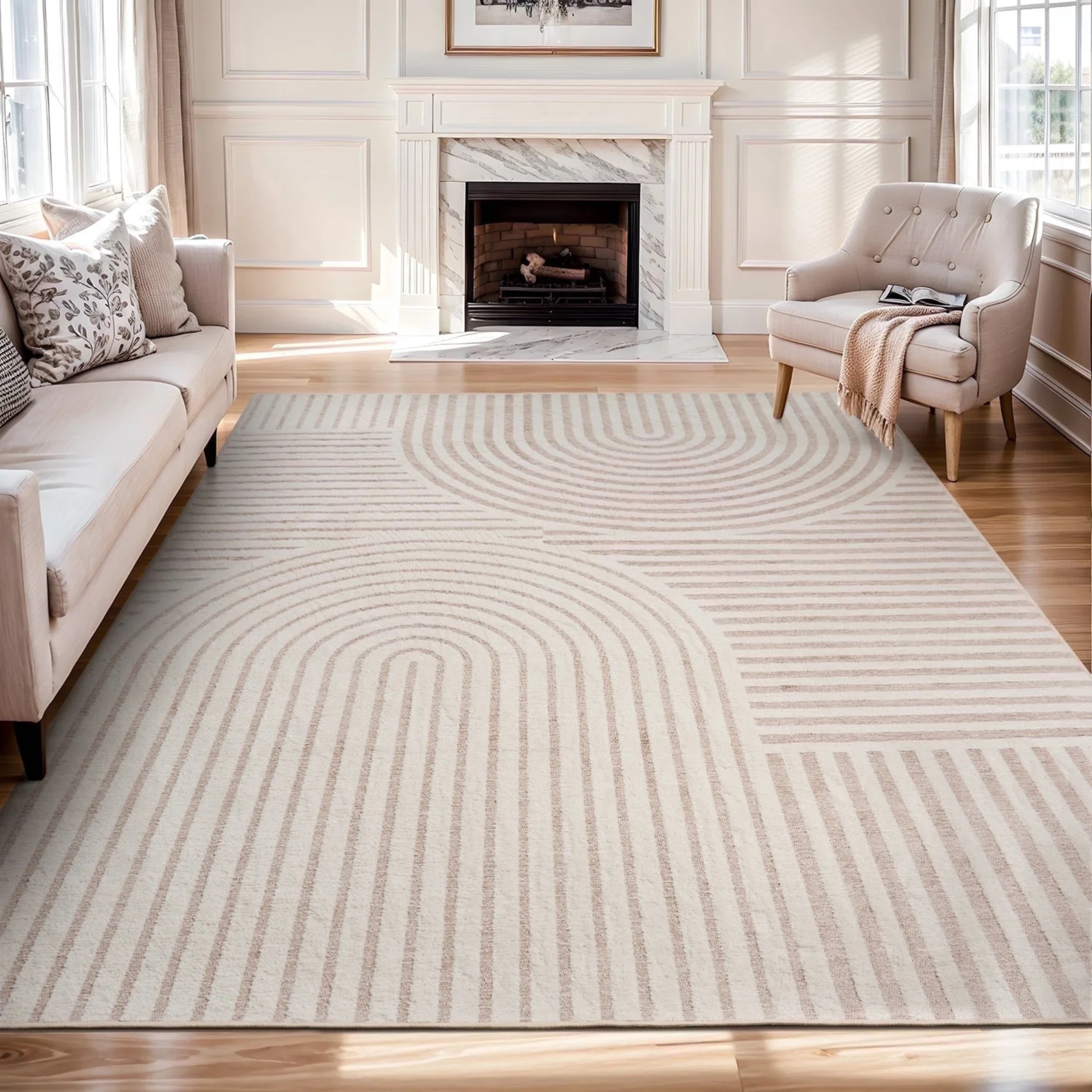 A greige patterned rug in a living room, under a sofa and armchair