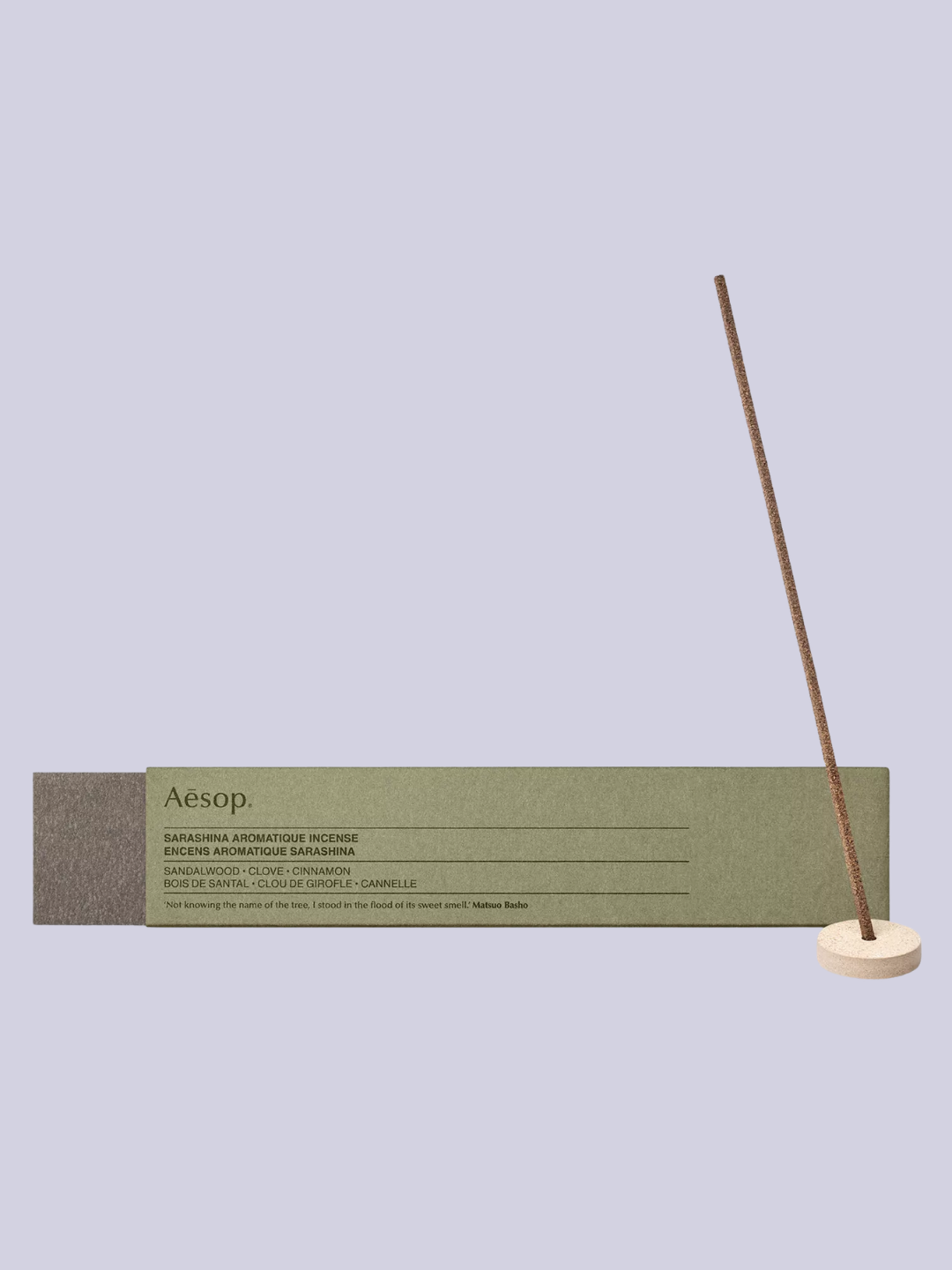 A green box of brown incense sticks and a mini holder from Aesop