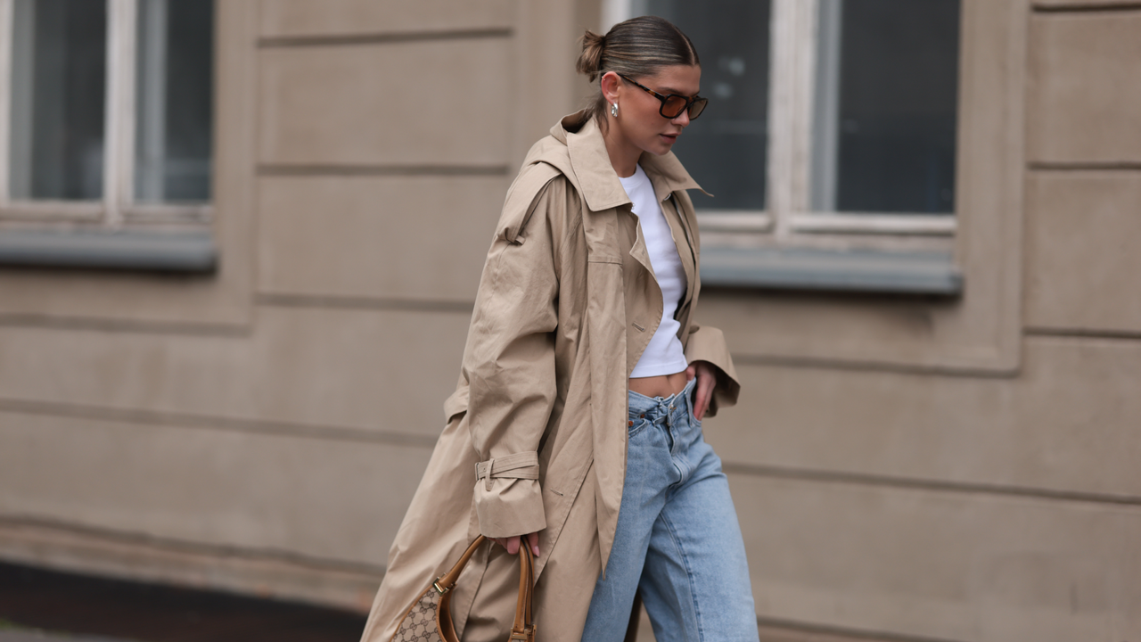 Sophia Geiss seen wearing Vehla Eyewear brown sunglasses, silver chunky earrings, Uniqlo white cotton basic cropped shirt, Levi&#039;s light blue denim / jeans pants, COS beige oversized long coat / trenchcoat, Gucci vintage brown canvas logo pattern bag and LeGer black leather loafers, on April 22, 2024 in Berlin, Germany. (