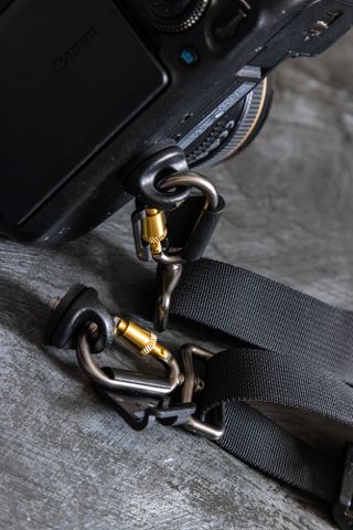 A close-up of the carabiners on the BlackRapid Double Breathe Dual Camera Harness Strap