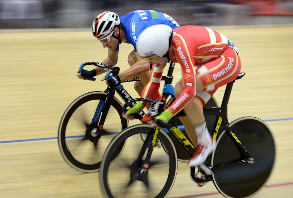 Gold medalist Elia Viviani of Italy (L) competes with silver medalist Lasse Norman Hansen of Denmark during the Men's Omnium competition at the Track Elite European Championships