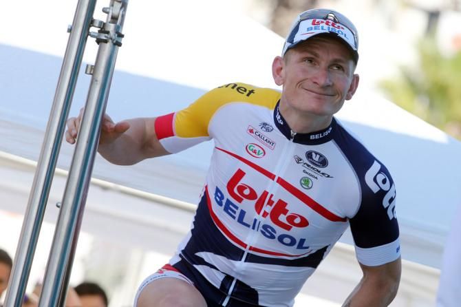 Stage 4 winner Andr&eacute; Greipel steps onto the stage for the podium ceremony.