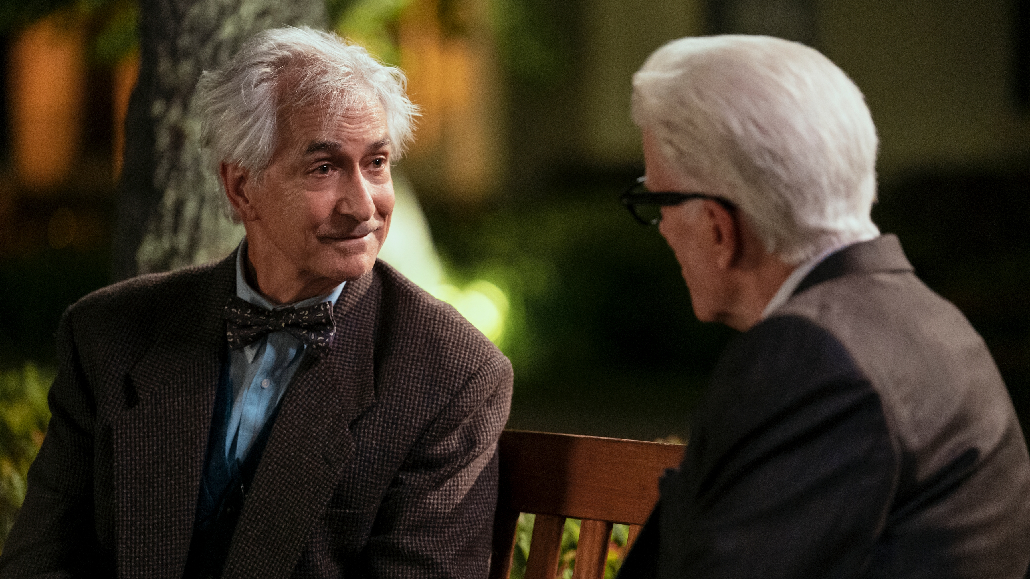 L-R: Benjamin Cole (David Strathairn) and Charles (Ted Danson) sit on a bench in a scene from "A Man on the Inside" season 2