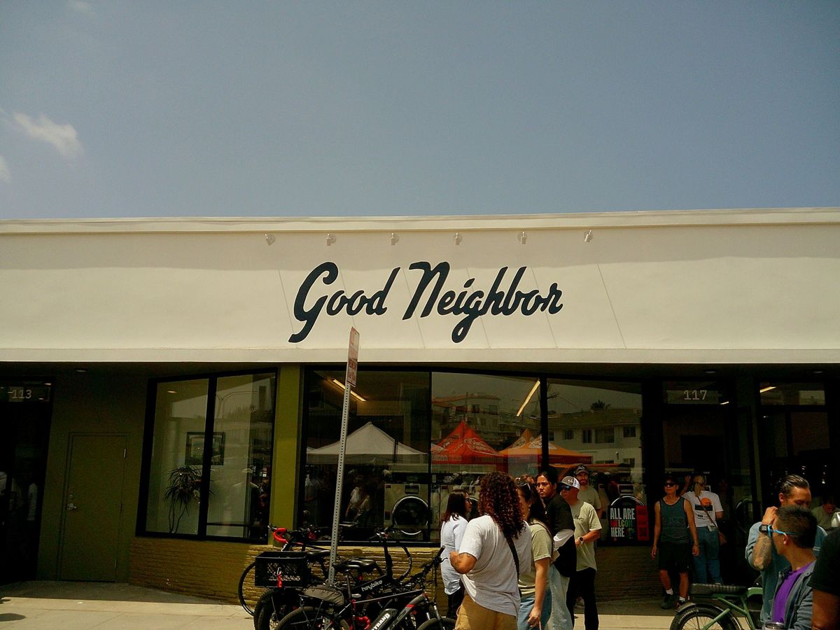 Sample image taken with Camp Snap 2 digital camera showing a storefront with the name 'Good Neighbor', beneath a blue sky