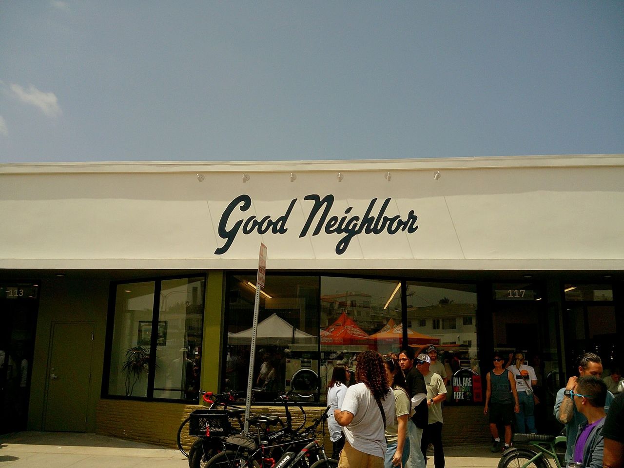 Sample image taken with Camp Snap 2 digital camera showing a storefront with the name 'Good Neighbor', beneath a blue sky