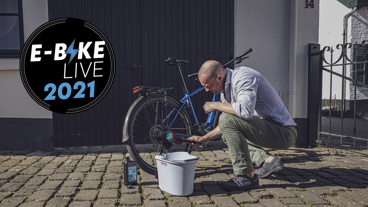 Man cleaning an electric bike