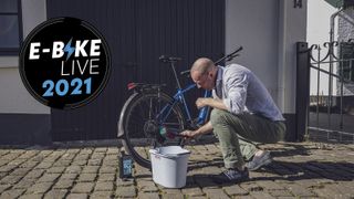 Man cleaning an electric bike