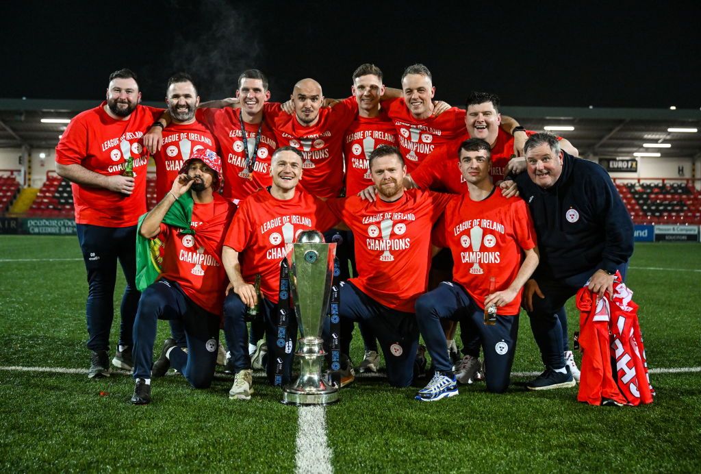 Derry , United Kingdom - 1 November 2024; Shelbourne staff, back row, from left, kitman Karl Watson, team doctor Anthony Hoban, coach David McAllister, assistant manager Joey O&#039;Brien, technical director Luke Byrne, goalkeeping coach Paul Skinner, kitman Graham Watson and kitman Johnny Watson, with, front row, strength and conditioning coach Mauro Martins, physiotherapist Rory Byrne, manager Damien Duff and video analyst Sam Mulhearn celebrate with the SSE Airtricity Men&#039;s Premier Division trophy after the SSE Airtricity Men&#039;s Premier Division match between Derry City and Shelbourne at The Ryan McBride Brandywell Stadium in Derry. (Photo By Stephen McCarthy/Sportsfile via Getty Images)