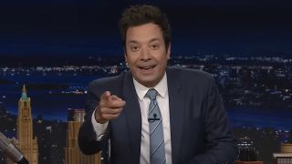 Jimmy Fallon smiling and pointing directly into the camera in The Tonight Show