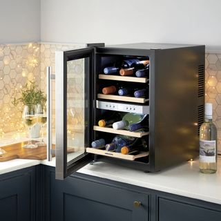 wine cooler on kitchen countertop with wine bottles