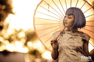 Woman with tattoos and parasol by Forest Woodward