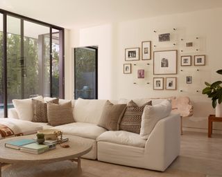 Relaxed, minimalist cream living room, sofa, gallery wall