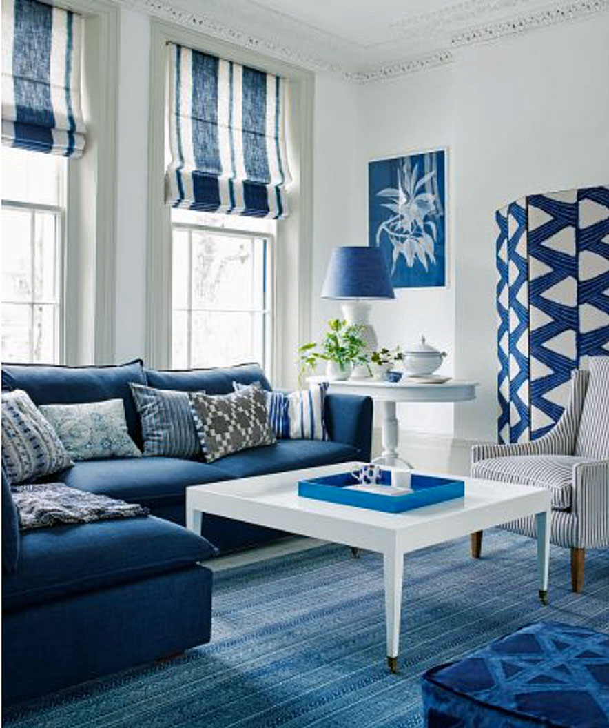 Blue and white living room color scheme with white walls and a blue L-shaped sofa.