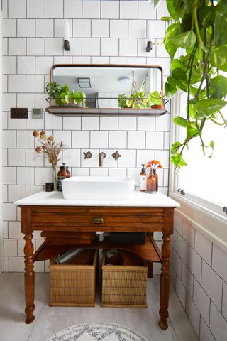 a small bathroom with Victorian wash hand basin and vintage mirror with shelving