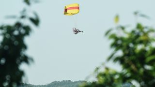 A staff member uses a powered parachute to search for three leopards that had escaped from the Hangzhou Wildlife World. The search took place in the mountains near Hejia Village in Hangzhou, the capital of east China's Zhejiang Province, on May 9, 2021. 