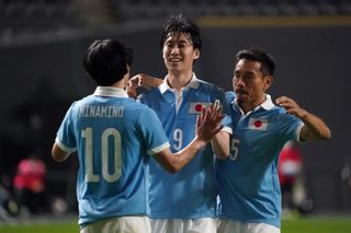 Japan players celebrate a goal against the nation's Under-24 side in June 2021.