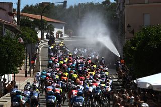 SEVILLE SPAIN AUGUST 21 The fans refresh the peloton during La Vuelta 79th Tour of Spain 2024 Stage 5 a 177km stage Fuente del Maestre to Seville UCIWT on August 21 2024 in Seville Spain Photo by Dario BelingheriGetty Images