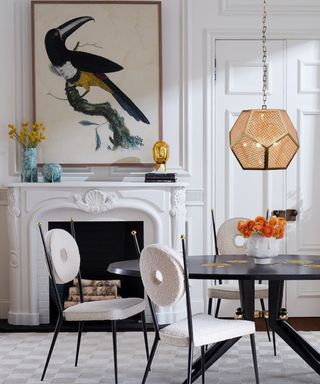 Modern dining room with boucle dining chairs, wall art and statement rattan pendant light