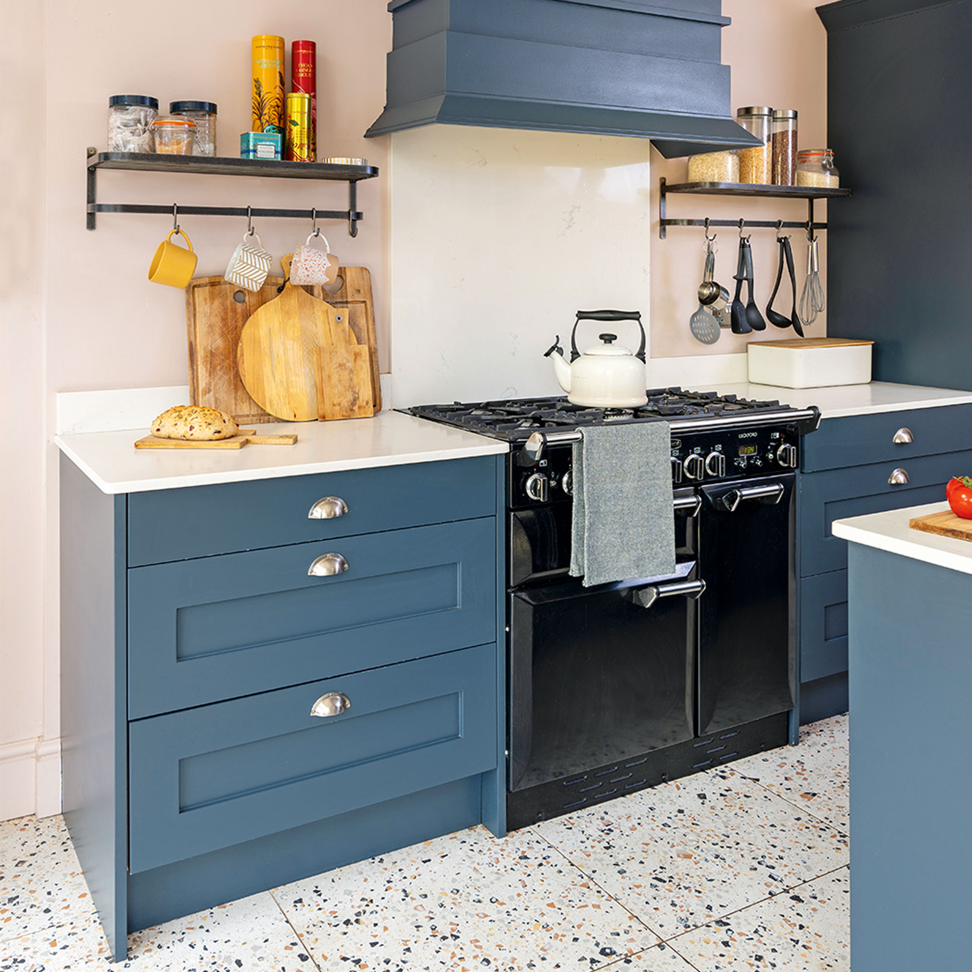blue kitchen with cabinets and oven