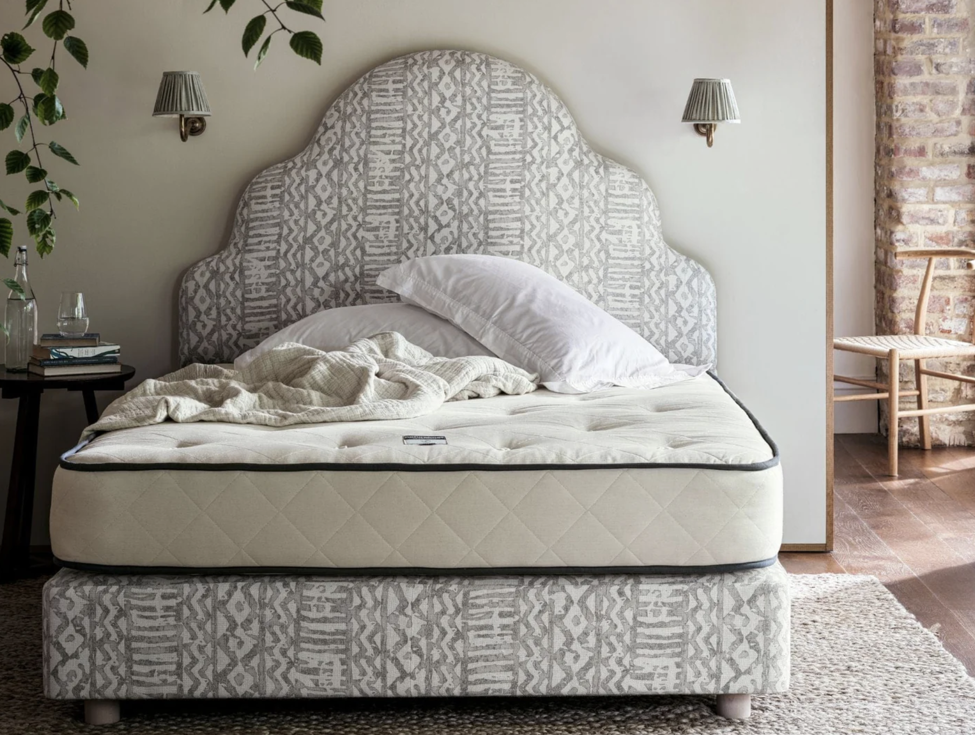 bed with large gray headboard