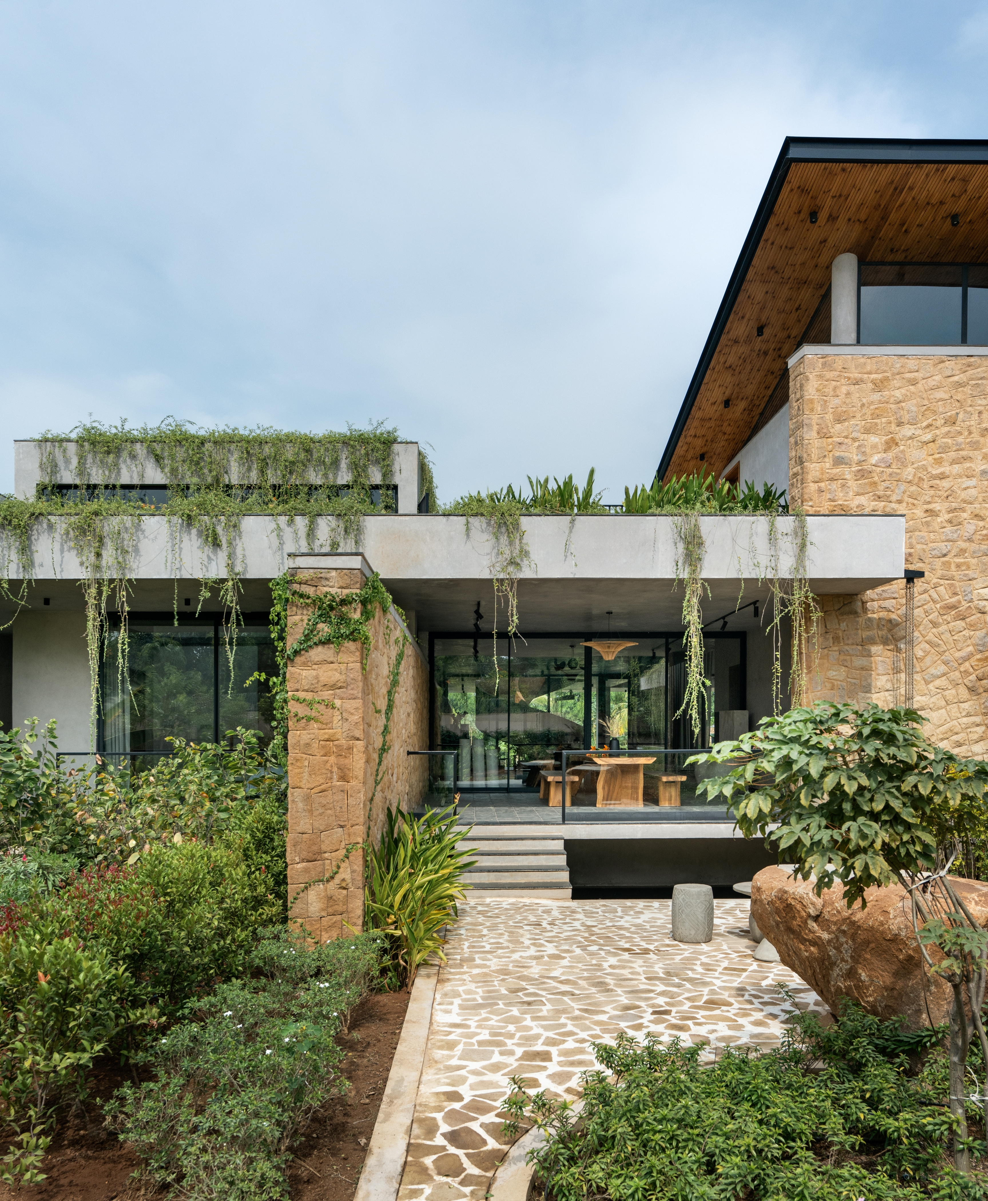 hyderabad home in brutalist style covered in greenery by 23 Degrees Design Shift