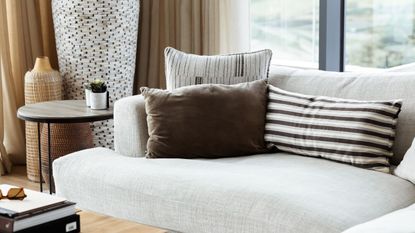 How to fix sagging couch cushions - A cream sofa with brown and cream throw pillows