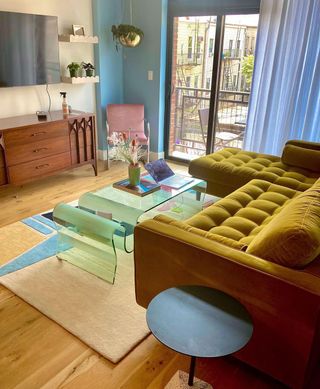 Ochre boxy sectional in small living room with green wave coffee table and geo area rug with blue and orange running through a caramel base.jpg