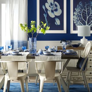 dining room with blue walls and table with chairs