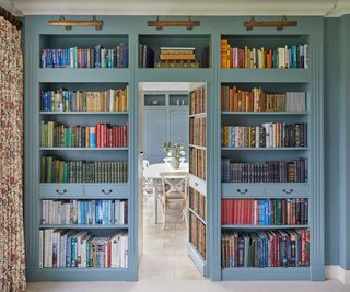 Blue built-in bookcase with a hidden door