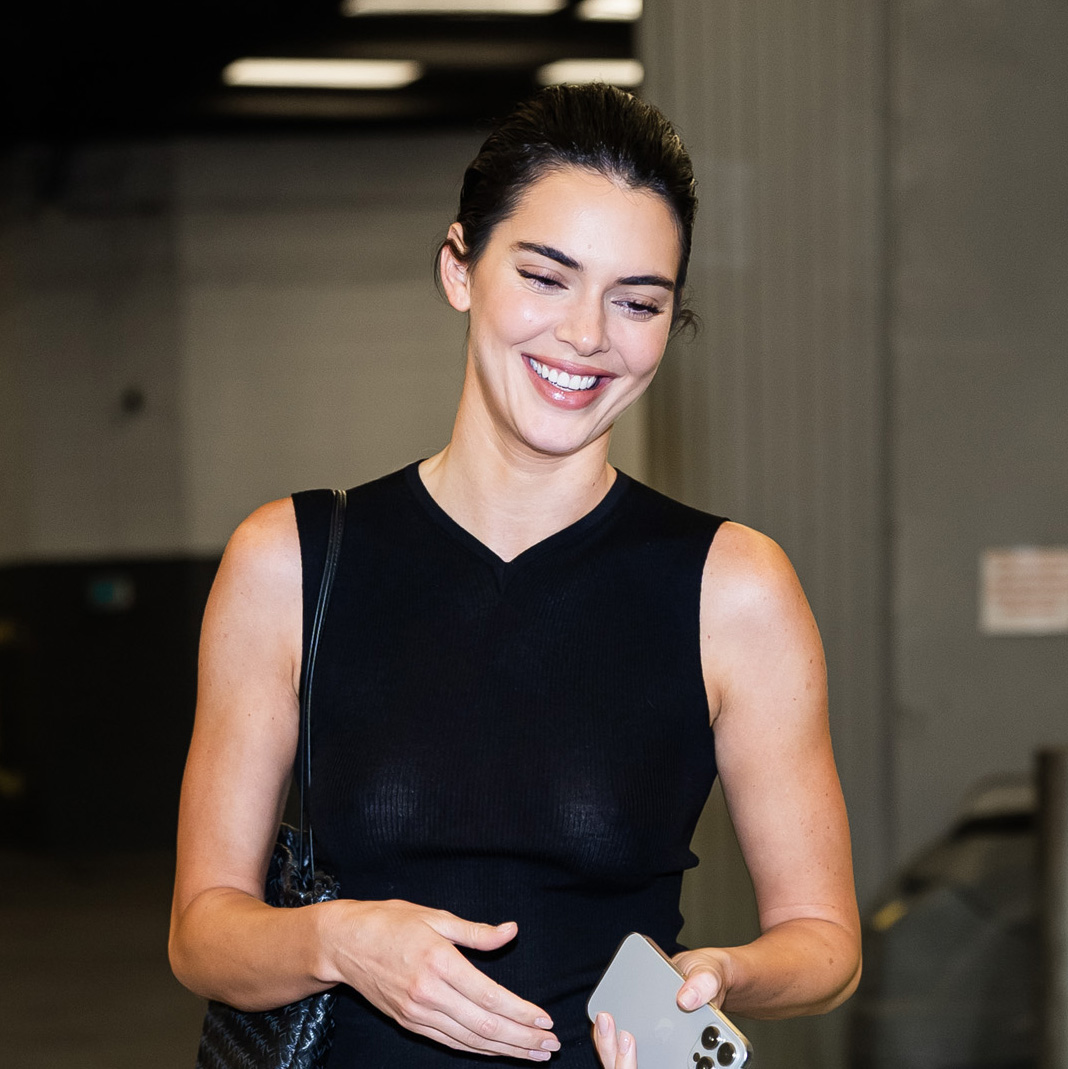 Kendall Jenner wearing a black top and white skirt