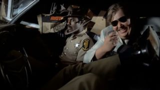 Steven Williams, Armand Cerami, and John Candy in The Blues Brothers