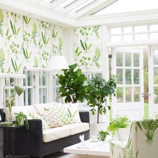 Interior of conservatory with white and green botanical blinds