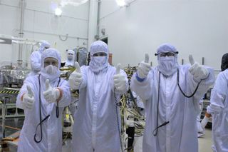 Technicians give NASA's Insight Mars lander a thumbs-up during a final round of testing at Lockheed Martin Space Systems Co. in Colorado. InSight is due to launch toward the Red Planet next year.