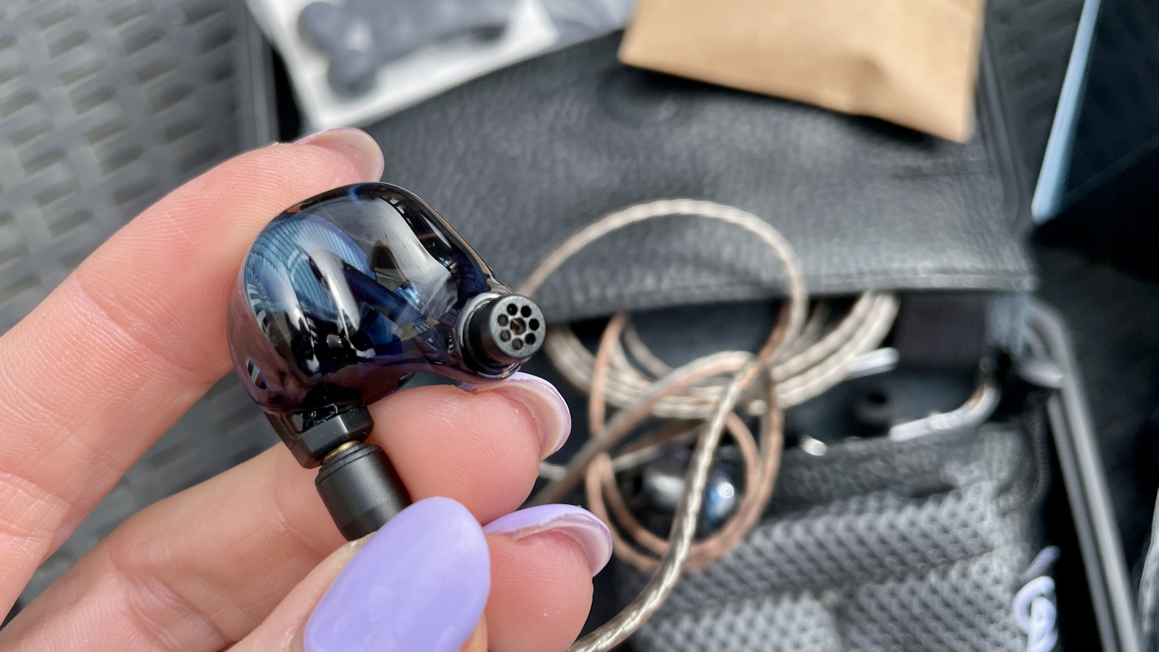 Campfire Audio Clara held in a hand, or worn by a woman