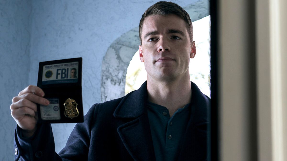 The Night Agent season 3: Gabriel Basso as Peter Sutherland holding up his FBI badge. 