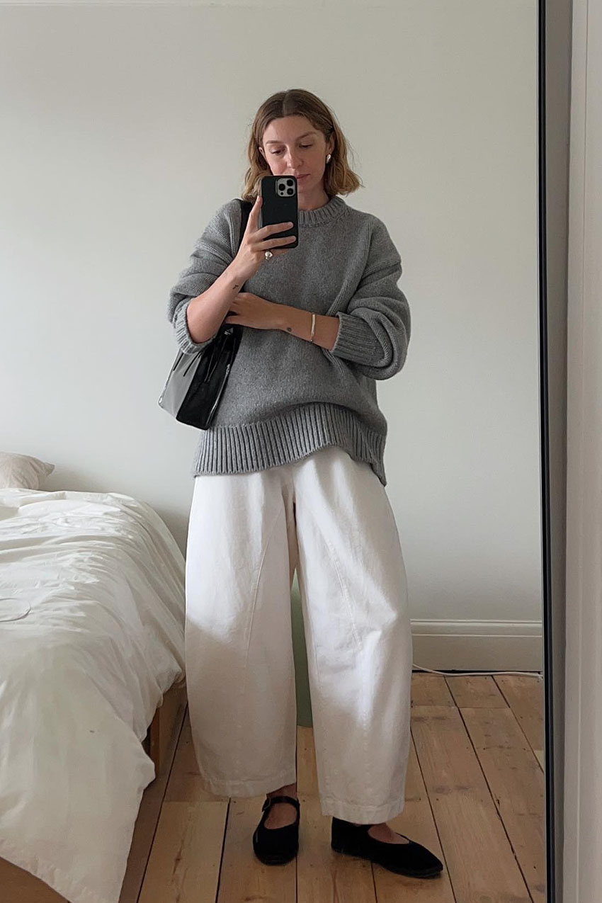 a woman wearing a gray sweater