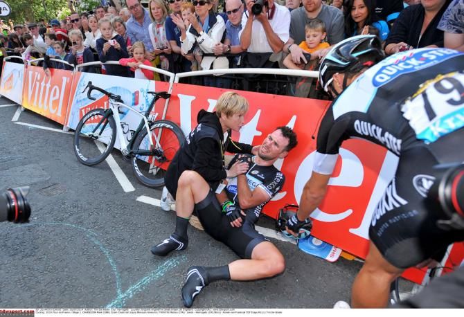 Mark Cavendish leaning on the barriers after his stage 1 crash