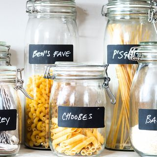 various pasta in glass canister with chalkboard labels