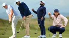 Rory McIlroy, Scottie Scheffler, Tyrrell Hatton and Tommy Fleetwood going through various stages of putting on the green