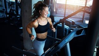 a photo of a woman running on a treadmill